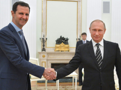 In this photo taken on Tuesday, Oct. 20, 2015, Russian President Vladimir Putin, right, shakes hand with Syria President Bashar Assad in the Kremlin in Moscow, Russia. Assad has traveled to Moscow in his first known trip abroad since the war broke out in Syria in 2011 to meet his strongest ally Russian leader Vladimir Putin, Syrian and Russian media reported Wednesday. (Alexei Druzhinin, RIA-Novosti, Kremlin Pool Photo via AP)